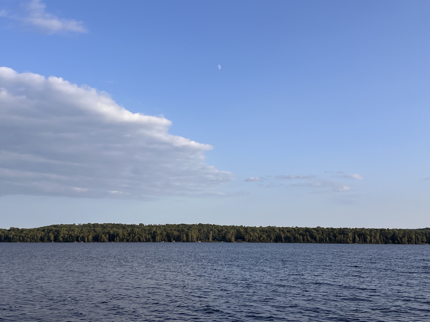 A clear blue sky and moon above the water after the smoke shifted